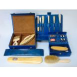 A collection of boxed ivory handled manicure items