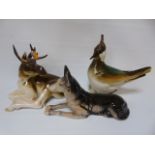 A Lemonosov figure of a moose another of a bird plus 1 other Russian figure of a dog