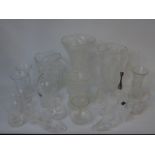 A collection of crystal glass vases and ornaments.