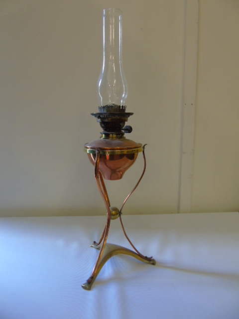 Art nouveau copper and brass oil lamp raised on 3 sinuous legs