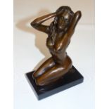 Bronzed of a nude female in a kneeling pose   Approx 8" high including the base