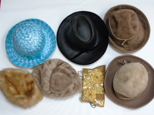 A box of vintage ladies hats and purses