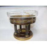 An art nouveau centrepiece glass dish raised on a metal base of 4 corinthian columns