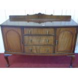 A mahogany sideboard fitted three drawers with cupboard doors to either side.