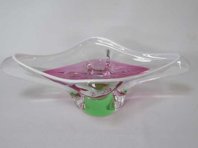 A Murano glass dish in pink, green and clear glass.