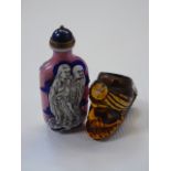 An oriental snuff bottle and a carved pipe bowl in the form of a mans head