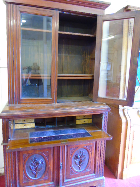 An Antique mahogany secretaire with carved decoration