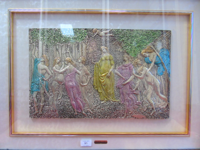 A Framed and glazed metallic plaque depicting a pre raphelite style scene of figures in a wood