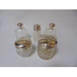 5 silver topped dressing table bottles with various assay marks