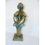 A heavy bronze figure of an angel seated on a plinth and playing a horn. approx height 23.5"