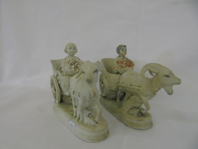 Pair of antique porcelain posy pots of cherubs in carts pulled by goats