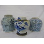 3 oriental blue and white jars one with cover.