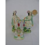 Pair of Staffordshire man and lady figures and a house pastille burner