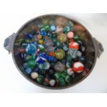 Metal bowl of various vintage marbles