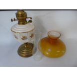 Brass and porcelain oil lamp with orange glass shade approx 23" tall