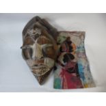 Carved African tribal mask and a silk hanging