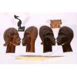 Four carved African wood heads, a small