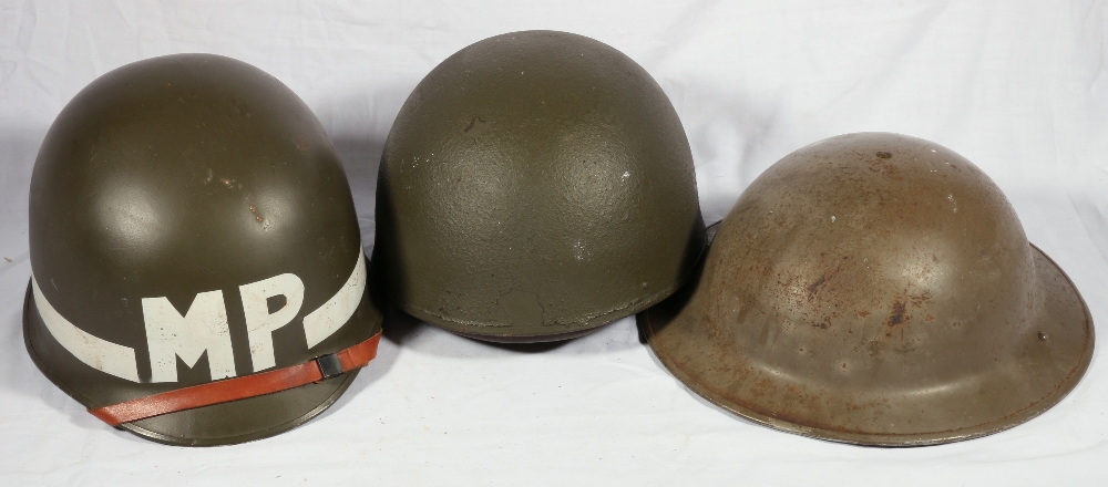 Three helmets, one with painted ensignia