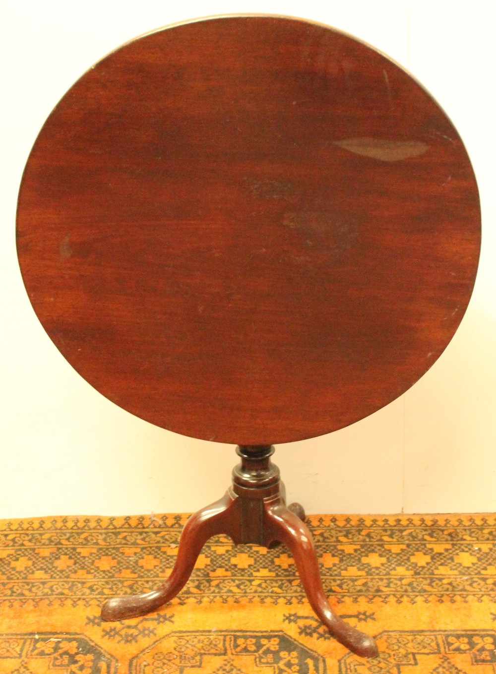 19th century circular mahogany snap-top table on turned pillar and tripod base, 76cm diameter.