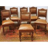 Set of six Edwardian carved oak dining chairs with decorated top rail, fixed seats and turned legs.