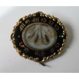 Victorian gold mourning brooch with enamelled band.