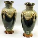 Pair of Royal Doulton stoneware vases by Minnie Webb, the blue-green ground decorated with applied
