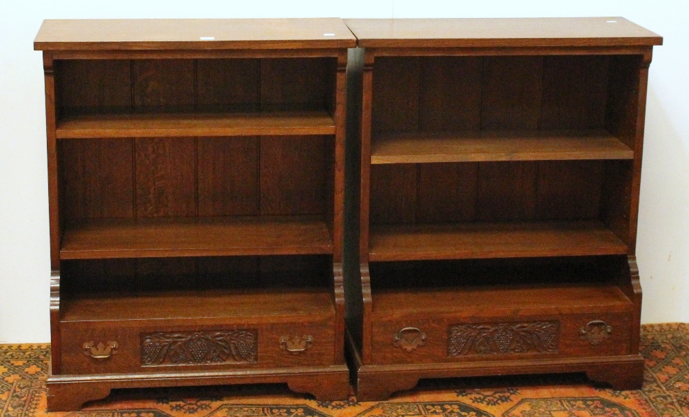 Pair of 20th century oak bookcases with base drawers, raised on bracket feet.
