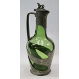 Art Nouveau style pewter wine decanter with grape and vine decoration and partly-cased green glass