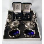 Silver six-piece condiment set of boat shape with shaped edges, includes two cased sets of