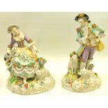 Pair of continental porcelain models of a shepherd and shepherdess with relief sheep and floral