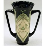 Moorcroft Snowdrop pattern twin-handled coupe, 15cm high.