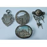 Indian silver brooch with miniature of a temple with minarets, a silver medal, a similar filigree