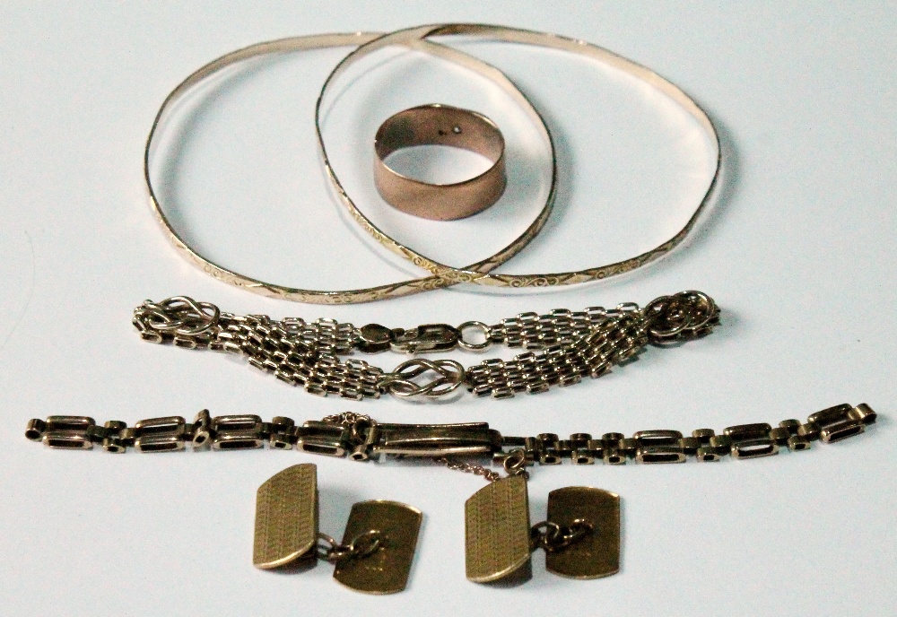 Two gold slave bangles, '10K', a band ring with a small diamond, a watch bracelet, a pair of