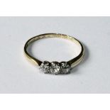 Diamond three-stone ring with brilliants of almost equal size, '18 & Pt'.