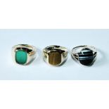 Signet ring with crocidolite (tiger's eye), another, chrysoprase, and a similar ring with carved