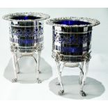 Pair of EP jardinieres or confitures with blue glass liners upon fluted legs, 23cm.