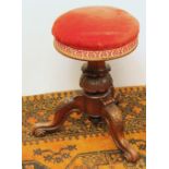 Victorian walnut adjustable stool raised on tripod base, 47cm high.