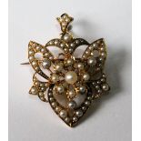 Victorian brooch/pendant of openwork shield shape set with pearls, probably 15ct gold.