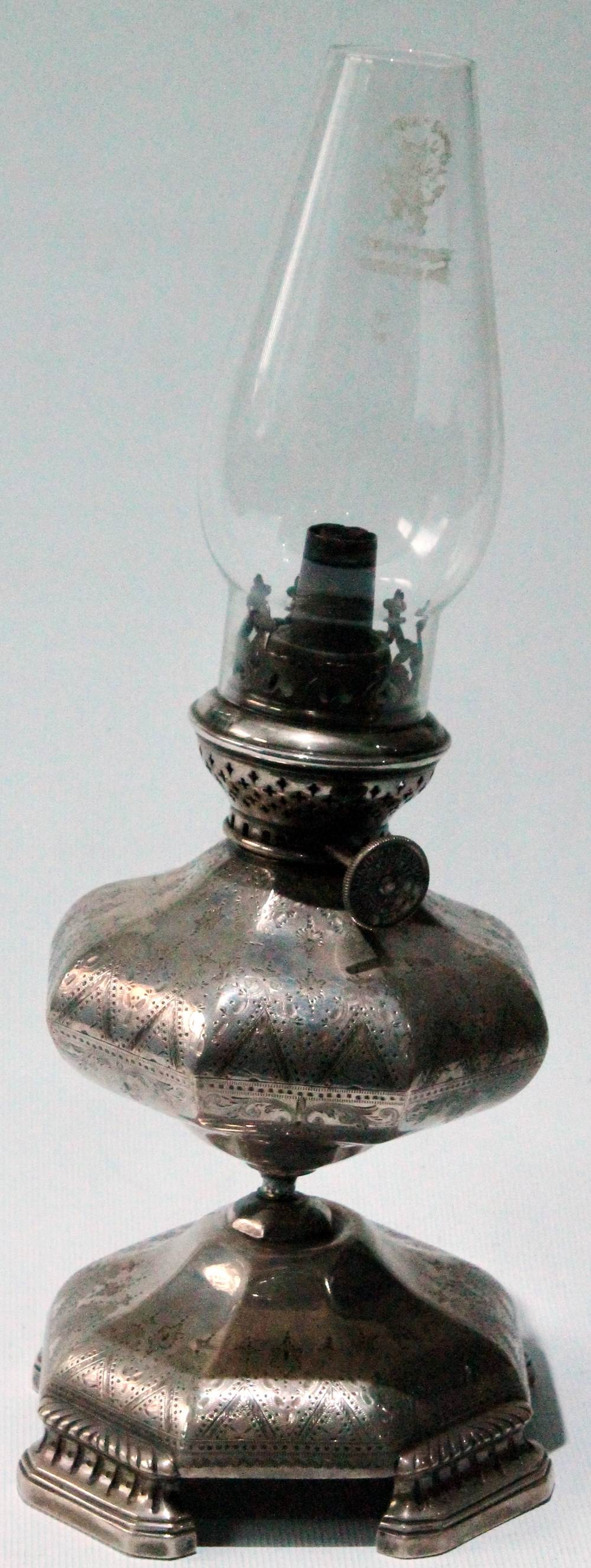 19th century silver oil lamp of octagonal, engraved, panelled form upon similar spreading base and