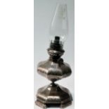 19th century silver oil lamp of octagonal, engraved, panelled form upon similar spreading base and