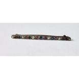 Edwardian line brooch with alternating diamonds, rubies and sapphires, slightly graduated in gold