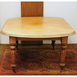 Victorian mahogany telescopic dining table with additional leaf, raised on fluted supports capped