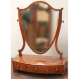 George III mahogany and boxwood strung shield-shaped toilet mirror with three frieze drawers.