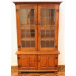 20th century carved oak bookcase with finger carved border and a pair of leaded glass doors with
