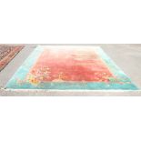 Chinese washed wool carpet with rose ground and turquoise border, 400cm x 300cm.