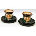 Pair of Royal Doulton character match holders, 10.5cm diameter.