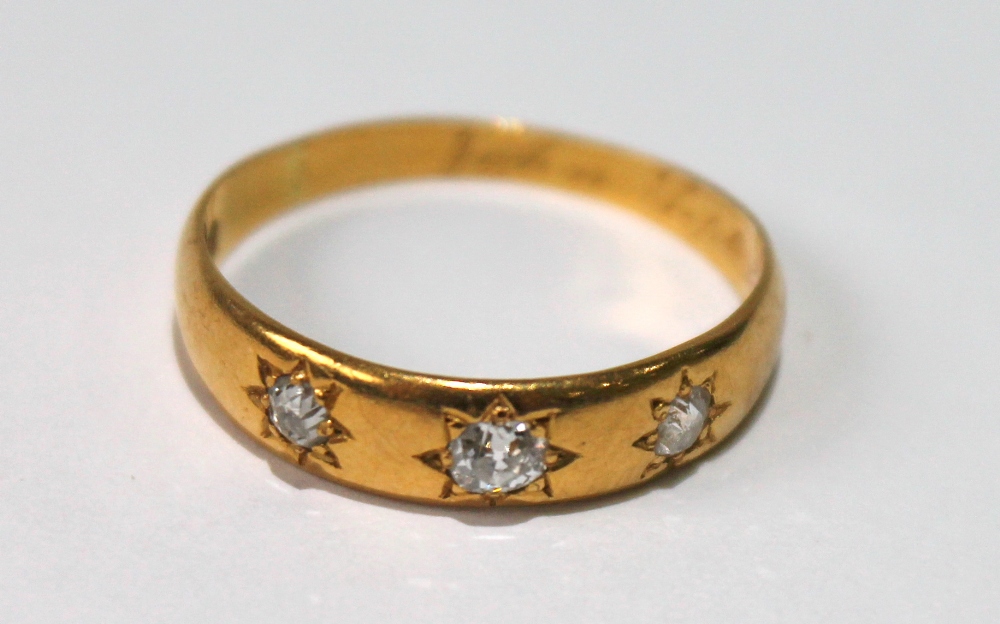 Diamond three-stone ring with brilliants star-set in 18ct gold, 1889. Condition Report 22ct gold,