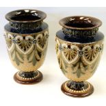 Pair of unmarked Doulton Lambeth style stoneware vases in green, brown and blue with shield-shaped