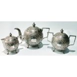 Indian silver three-piece tea set of globular shape, embossed with scrolls, 24oz.