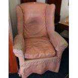 Regency mahogany wing armchair with scroll arms on turned brass capped legs and brass castors,